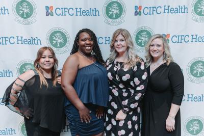 People pose in front of CIFC backdrop