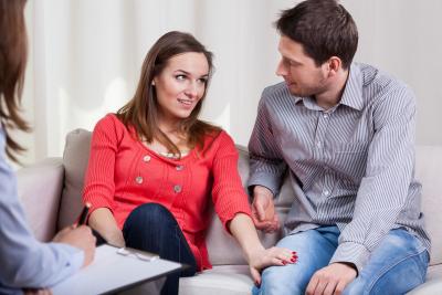 Man and women on couch talking to therapist