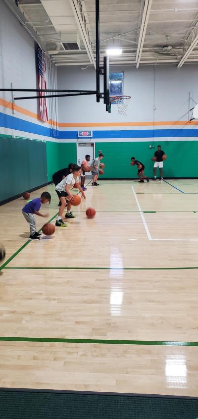 kids on baseline dribbling basketballs