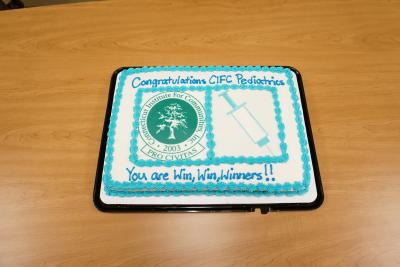 Cake with CIFC logo and hypodermic needle