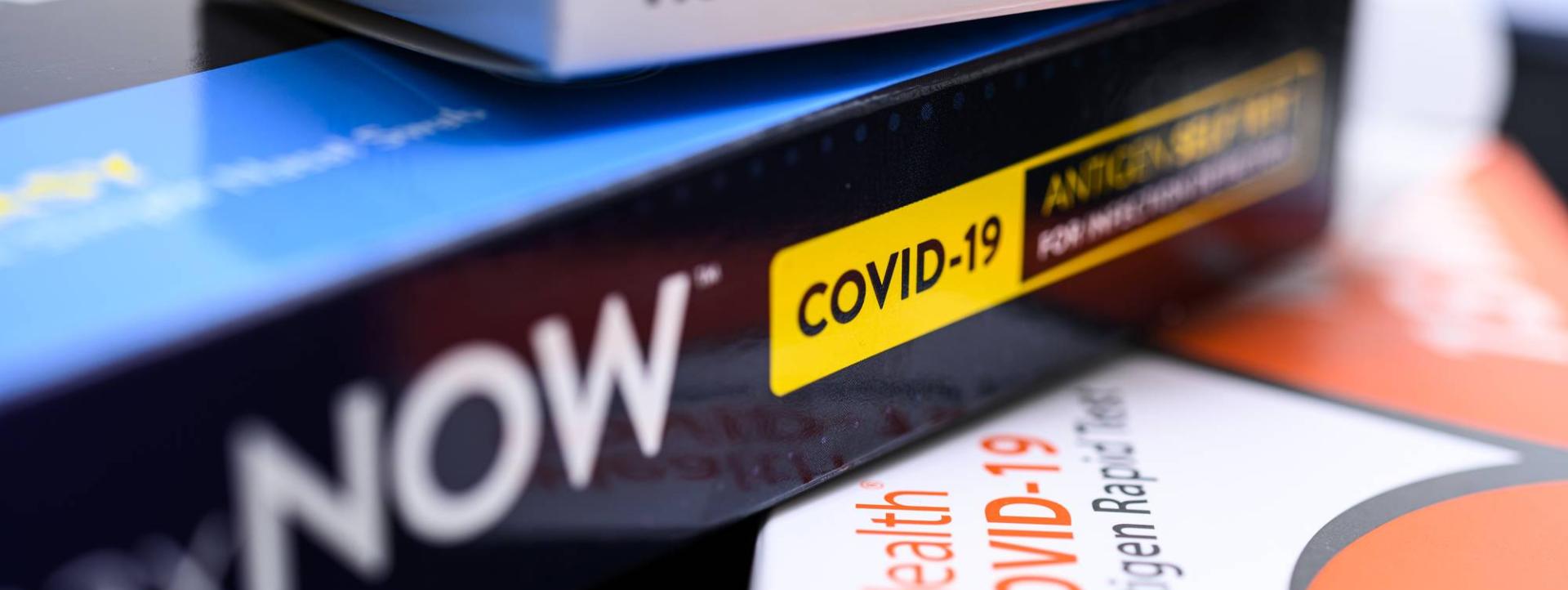Covid test kits in a stack